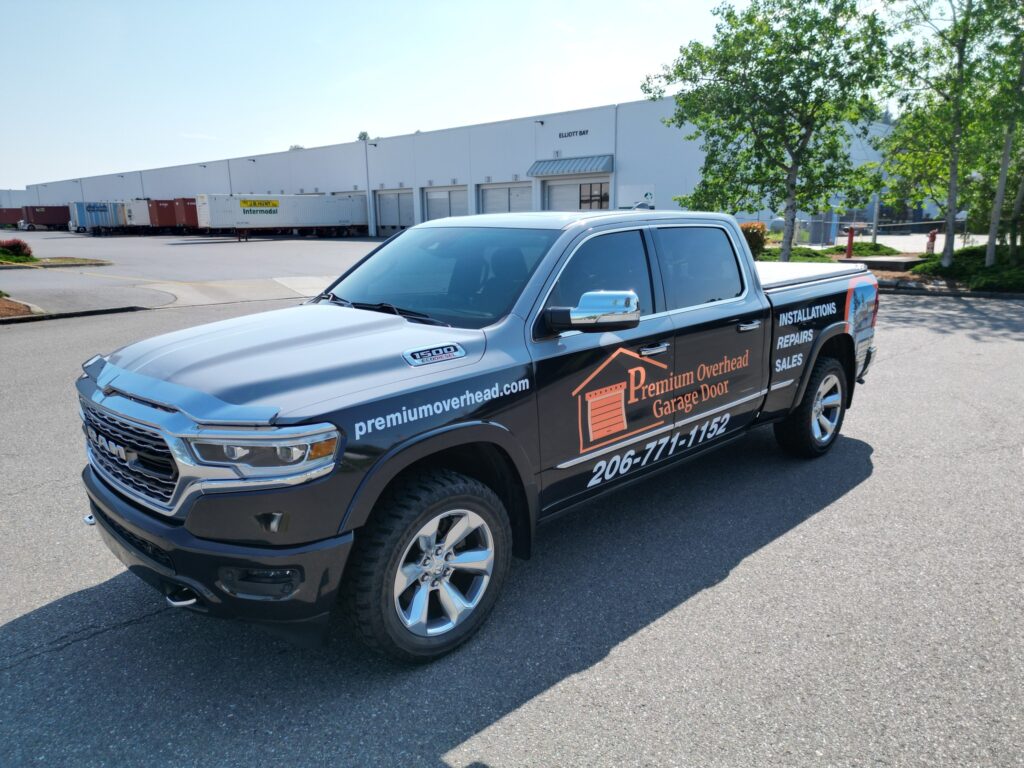 Technician applying vinyl during truck vehicle wrap installation