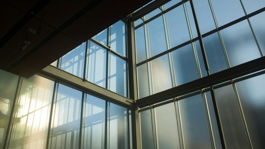Purple discolored and bubbling window film on a commercial building window